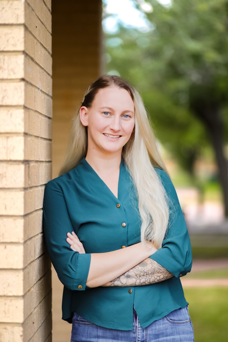 Heather Stewart smiling outside in a teal blouse